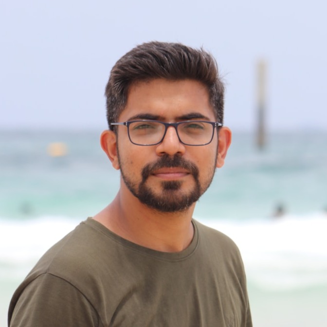 man in black framed eyeglasses and gray crew neck shirt